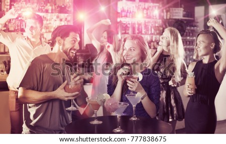 Young students dancing on party with a cocktails at club