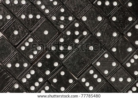 Domino cards fill a table. Diagonal view of tilled dominoes on a table