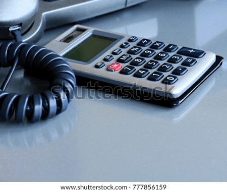 image of calculators and phone sitting on a office table no peopple stock photo