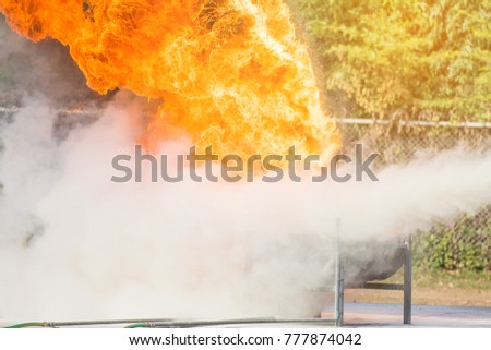 Instructor training how to use a fire extinguisher for fighting fire
