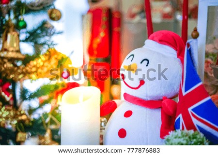 Snowman in Christmas holiday and candle of happiness
