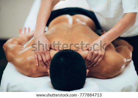 Sports massage. Therapist working with shoulders Royalty-Free Stock Photo #777884713
