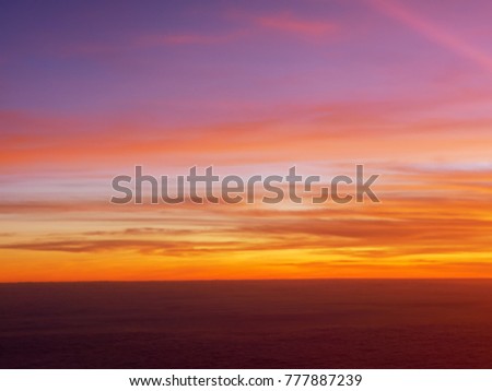 Natural Sunset Sunrise Over Field Or sky. Bright Dramatic Sky And Dark Ground. Countryside Landscape Under Scenic Colorful Sky At Sunset Dawn Sunrise. Sun Over Skyline, Horizon. Warm Colours.
