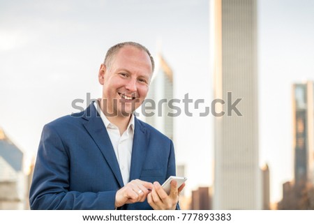 Businessman using mobile phone outside the offices