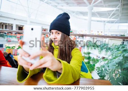 woman take selife in cafe in shopping mall