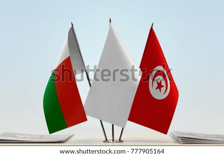 Flags of Madagascar and Tunisia with a white flag in the middle