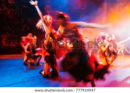 an abstract blurred, soft focal picture with long exposure is an illustration of the ballet's performance on modern stage. Bright theatrical abstract background with creative artists in motion blur