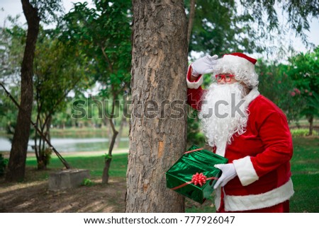 Santa claus with gift box in the forest,Thailand people,Sent happiness for children,Merry christmas,Welcome to winter