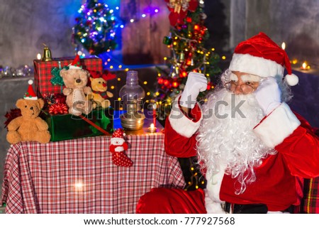 Stress Santa claus at home,Sit on chair think about plan for sent gift box for give children