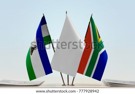 Flags of Lesotho and Republic of South Africa with a white flag in the middle