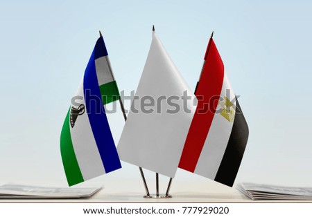 Flags of Lesotho and Egypt with a white flag in the middle