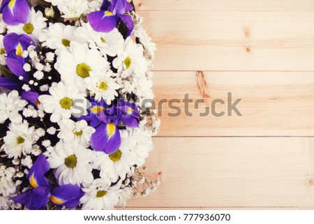 A bouquet of white chrysanthemums and blue irises