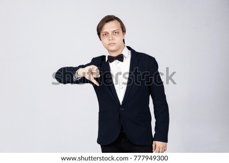 Disappointed business man with thumb down