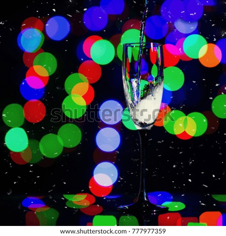 Glass of champagne on bright background with bokeh effect