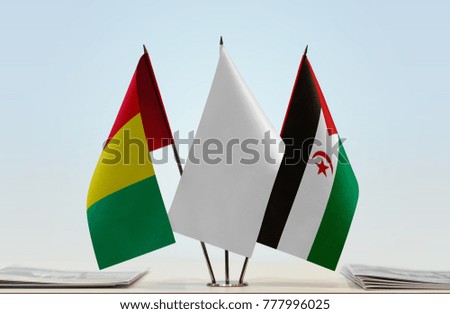 Flags of Guinea and Sahrawi Arab Democratic Republic with a white flag in the middle