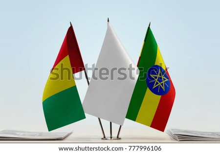 Flags of Guinea and Ethiopia with a white flag in the middle