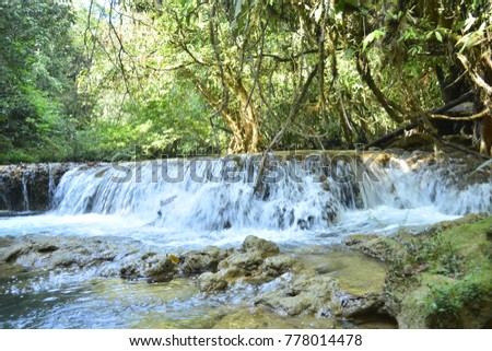 A small waterfall in the tropical forest of Kanchanaburi, Thailand. Out of focus