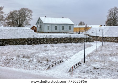 Snow covered bastions of ancient fortress in Hamina at dull winter day. Finland Royalty-Free Stock Photo #778025956