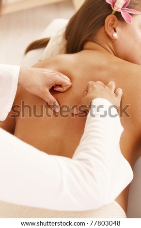 Closeup of masseur's hands doing back massage.?