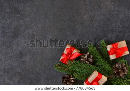 Black New Year background with decorations from fir, cones and gifts. Happy New Year and Merry Christmas