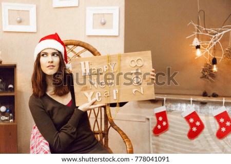 Beautiful girl in santa hat celebrate new year. Merry christmas
