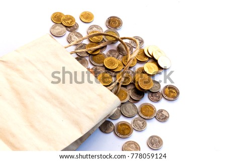Bag paper on the coin pile with have white background close up,For business design background,Not saving money and thriftless.Defocused and Blurred