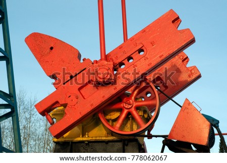 Crank, counter weight, pitman arm and revolving flywheel of oil pumpjack Royalty-Free Stock Photo #778062067