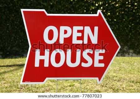 Real Estate Open House sign in a yard outside