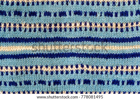 Background texture of blue pattern knitted fabric made of cotton or wool closeup