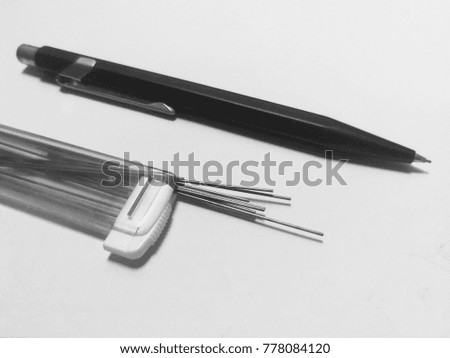 Pencil and refill lead in the plastic box on the white background.