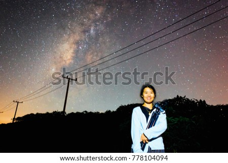 pretty Asian woman night portrait with milky way and stars background