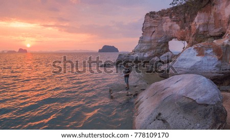 photographer take picture by drone in front of the hole in the cape  during sunset time.Leam Jamookkwy or Buffalo Nose cape is in Thalane Krabi