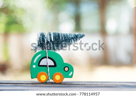 Wooden car carrying a christmas tree.
