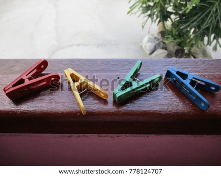 Clothespins many color on wood 