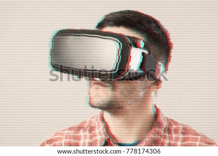 Man with VR goggles watching 360 video. Glitch effects added