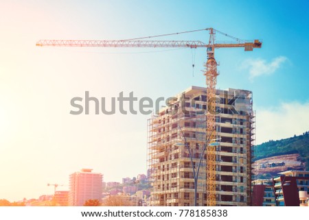 Construction site background. Building commercial project. Tower crane near the building Royalty-Free Stock Photo #778185838