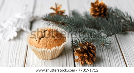 A festive Christmas composition with homemade muffins, cones and fur twigs