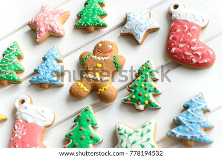 Christmas cookies with festive decoration and on white wooden background. New Year and Christmas concept.