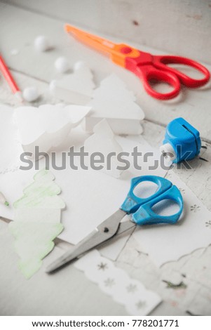 Christmas table with various items. Woman's hands putting a letter in an envelope