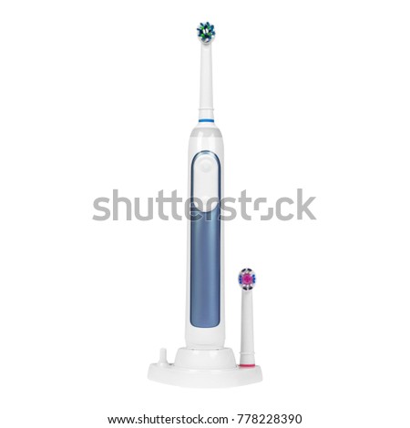 Electronic toothbrush on charge stand with replaceable brush head isolated on a white background