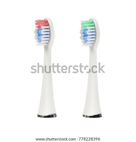 Two different replacement brush heads for electronic ultrasonic toothbrush isolated on a white background