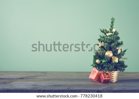 Festive Christmas tree stands on dark boards. Christmas background. Christmas decorations on a green background. Space for text. New Year's background. Toned image.