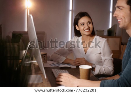 Young co-workers having late night meeting in office