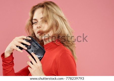   woman with a joystick on a pink background, game console                             