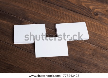 White business cards on wooden background. Mockup.