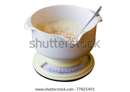 Kitchen scale with flour isolated on white background