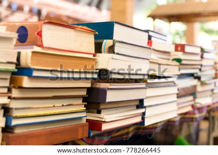 Piles of old books on a table in blur background Royalty-Free Stock Photo #778266445