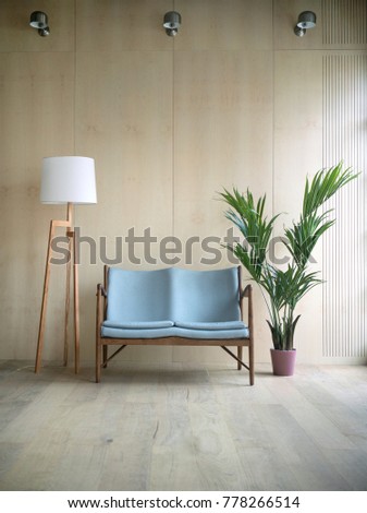 Spacious wooden living room designed with blue vintage sofa, tropical plant in pot and retro lamp. Scandinavian interior styled photo