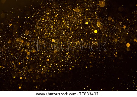 Magic glowing gold dust particles flowing abstract background  Royalty-Free Stock Photo #778334971