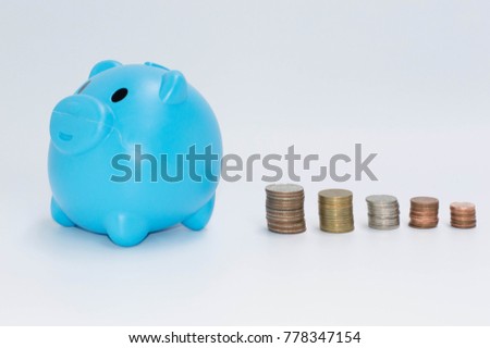 Savings with coins in blue piggy bank